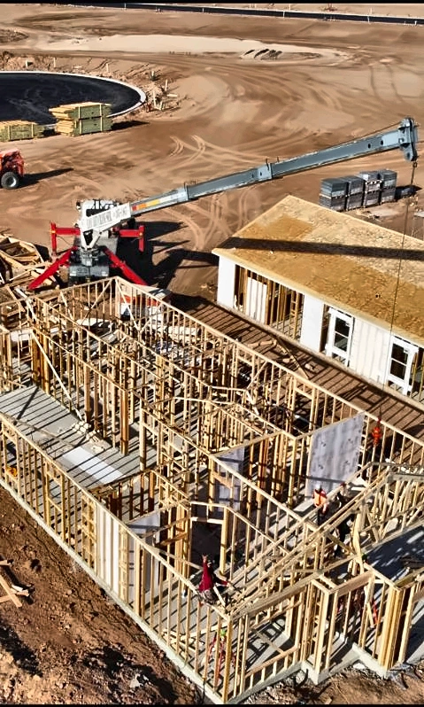 Aerial view of a crane and building framing at a jobsite