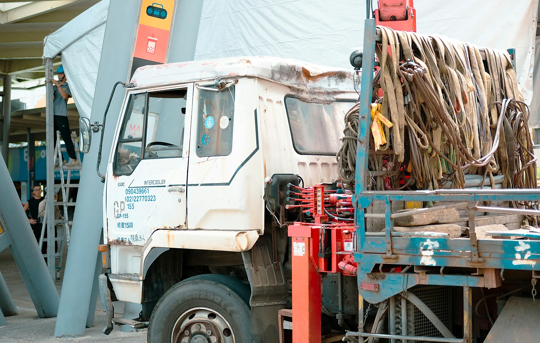 Truck-mounted crane handling equipment placement
